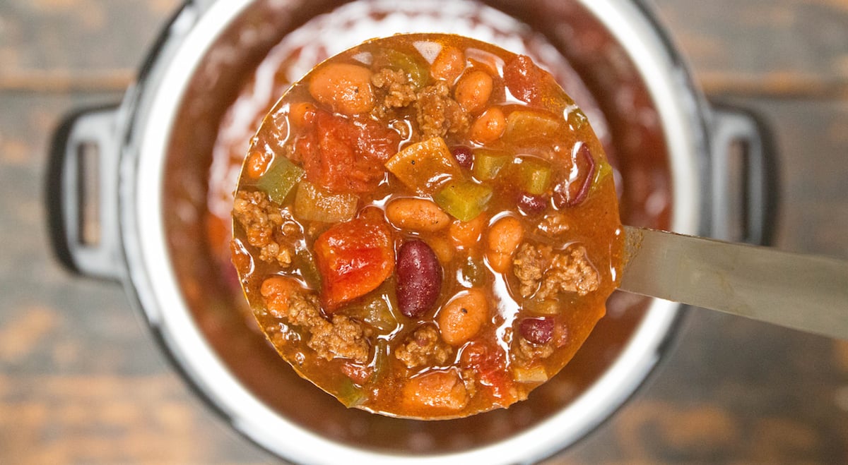 A ladle with copycat Wendys Chili over an Instant Pot