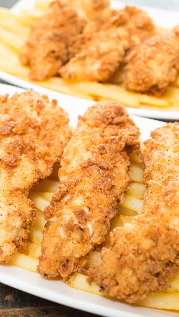 Buttermilk Chicken Tenders on top of a basket of fries.