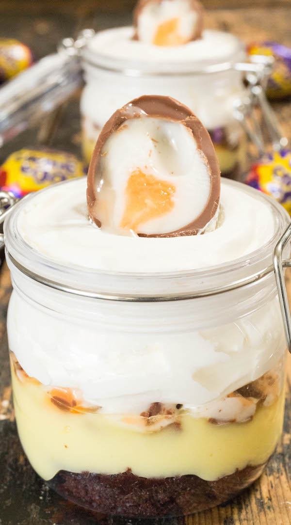 A jar filled Cadbury Creme Egg Parfait with layers of cake, pudding, and cool whip.