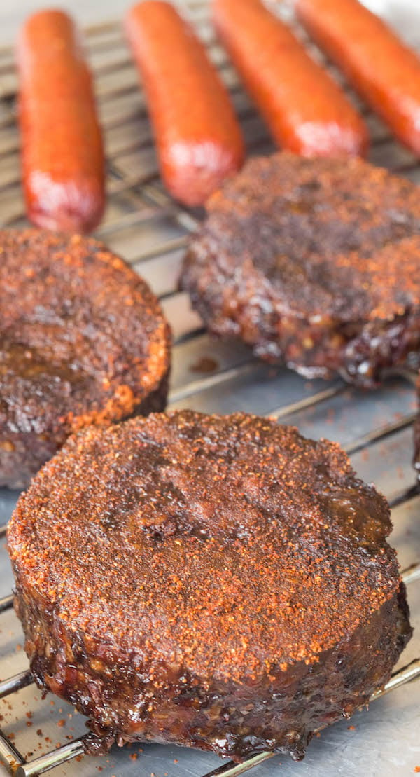 Smoked Hamburgers & Hot Dogs resting on a baking sheet.