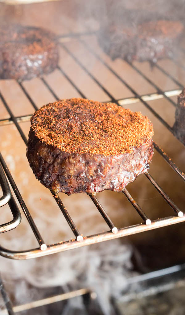 Smoked Hamburger patties on a rack in a smoker.