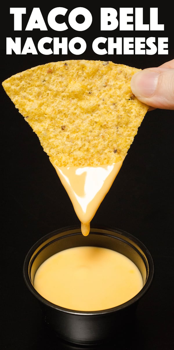 Close up of a tortilla chip that's been dipped in nacho cheese. Text at the top reads "Taco Bell Nacho Cheese"