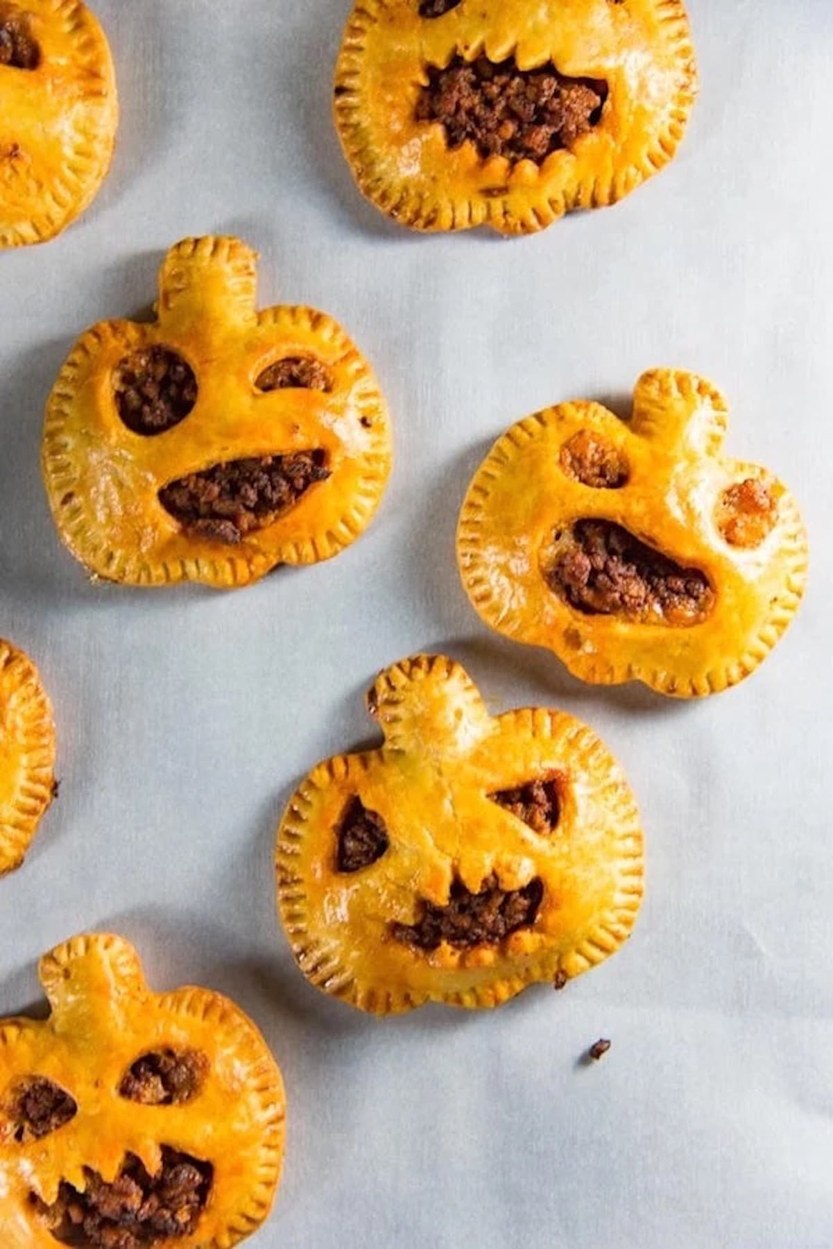 Hand pies have been cut into jack-o-lanterns and filled with a chorizo mixture.