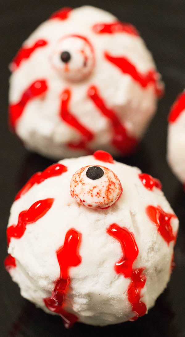 Close up of a Donut Hole Eyeball with a candy eye and red gel squiggly lines.