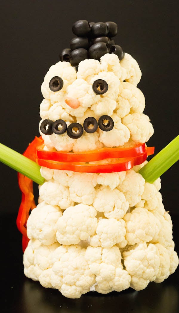 3-D Snowman Christmas Veggie Tray on a black background.