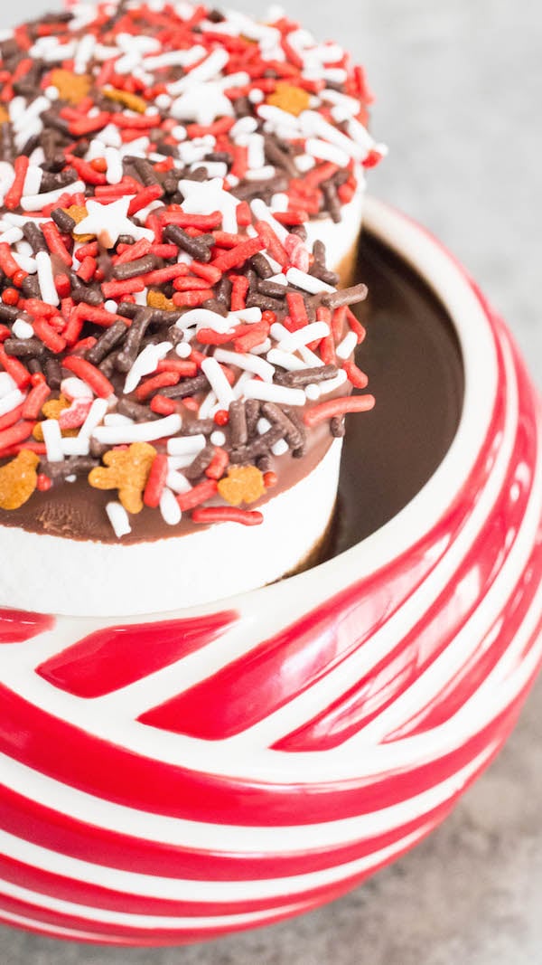 Close up of Crock Pot Peppermint Hot Chocolate in a candy cane striped mug.