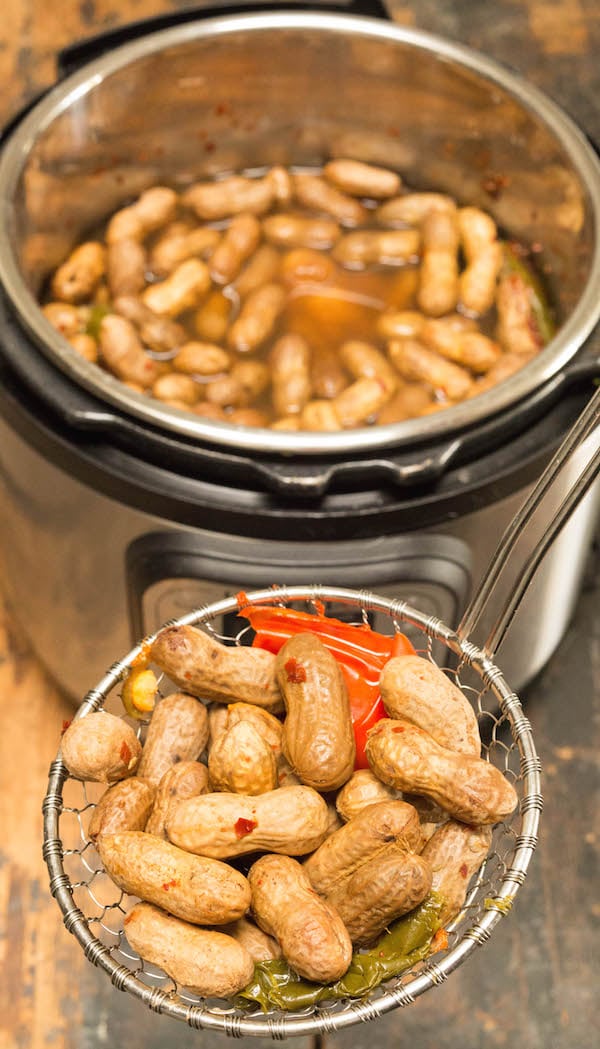 Instant Pot Cajun Boiled Peanuts scooped out from the inner pot.