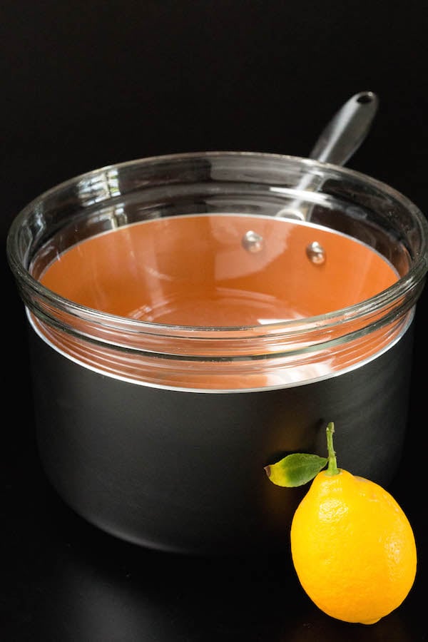 A glass bowl on top of a sauce pan (double boiler) to make Meyer Lemon curd.