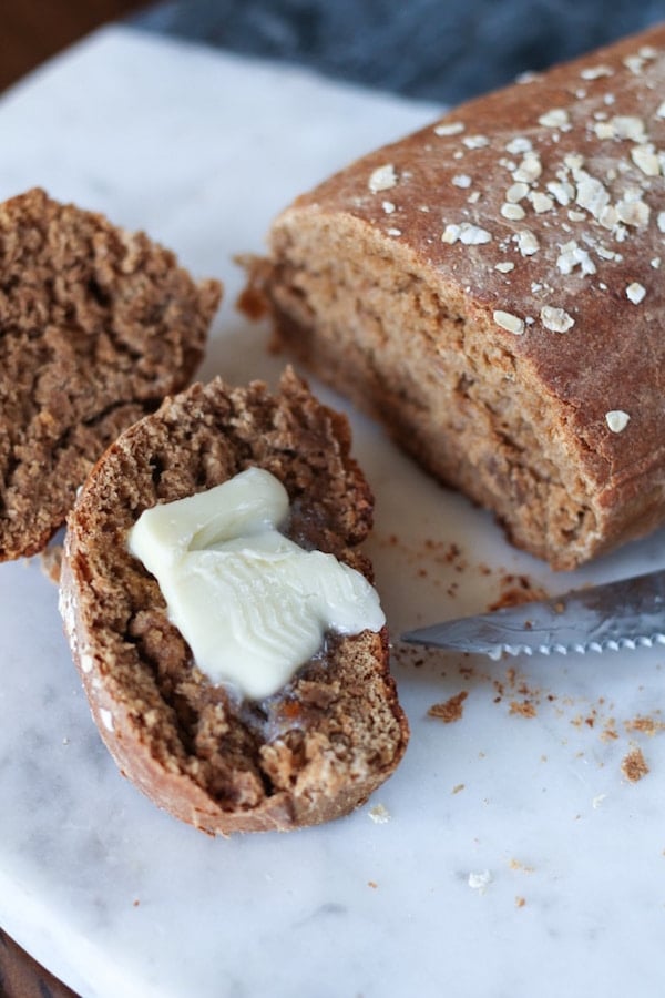 Sliced Cheesecake Factory brown Honey Wheat Bread with butter