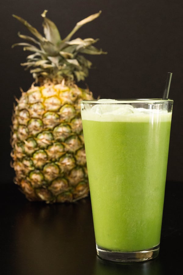 Homemade copycat Starbucks Matcha Pineapple Drink on a black background.