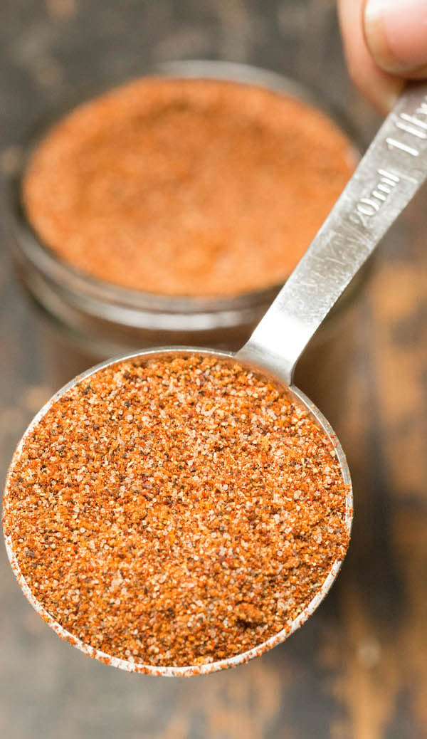 Close up of BBQ spice rub in a metal tablespoon.