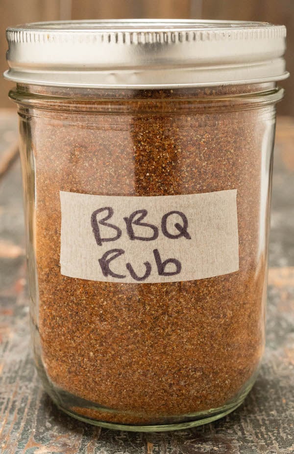 BBQ spice rib in a glass mason jar on a wood background.