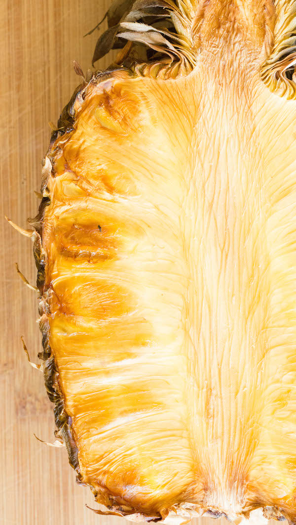 Close up of a smoked pineapple sliced in half