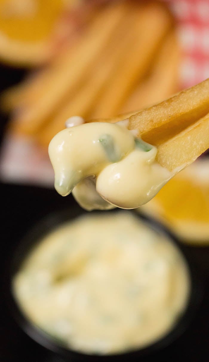 Close up of french fries dipped in lemon chive mayo