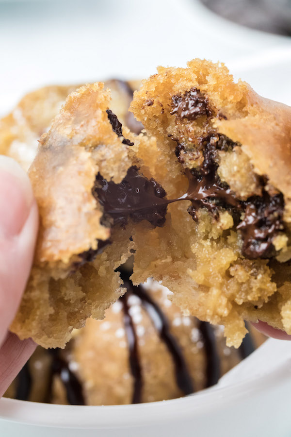 Close up of a fried cookie dough ball being torn open