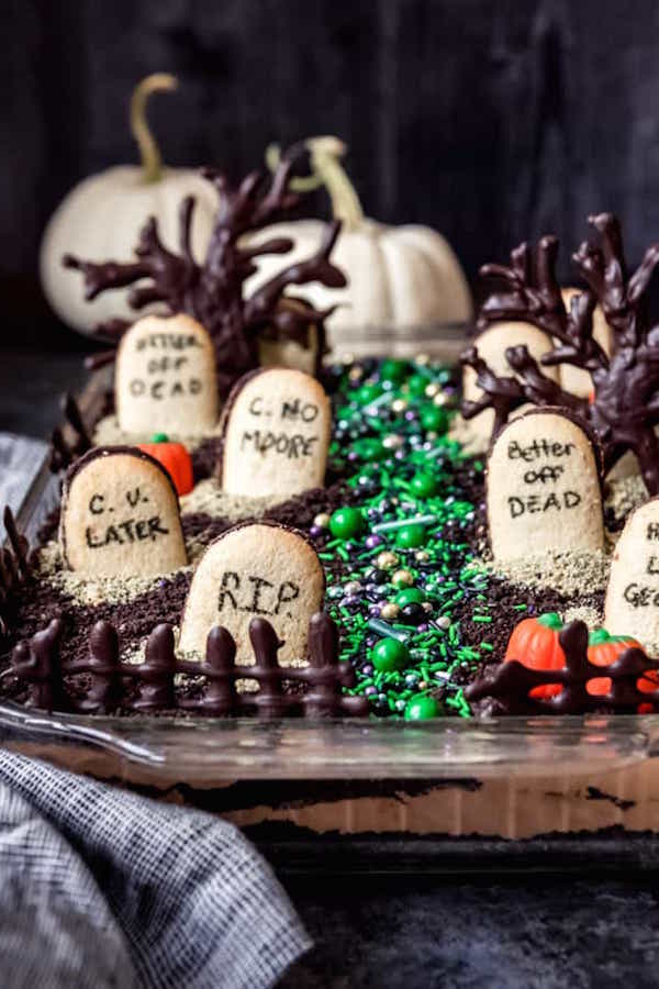 A chocolate cake in a casserole dish that looks like a graveyard. Milano cookies are used to look like gravestones that say "RIP"
