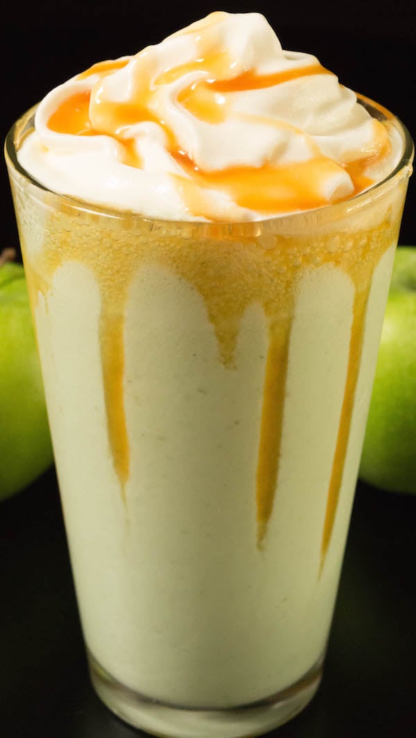 Closeup of a green caramel apple smoothie on a black background