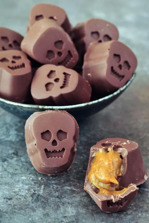 Skull shaped chocolates split open to see the pumpkin caramel inside. 