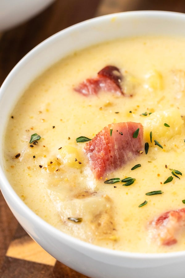 Closeup of a white bowl thats filled with Instant Pot ham and potato soup. 