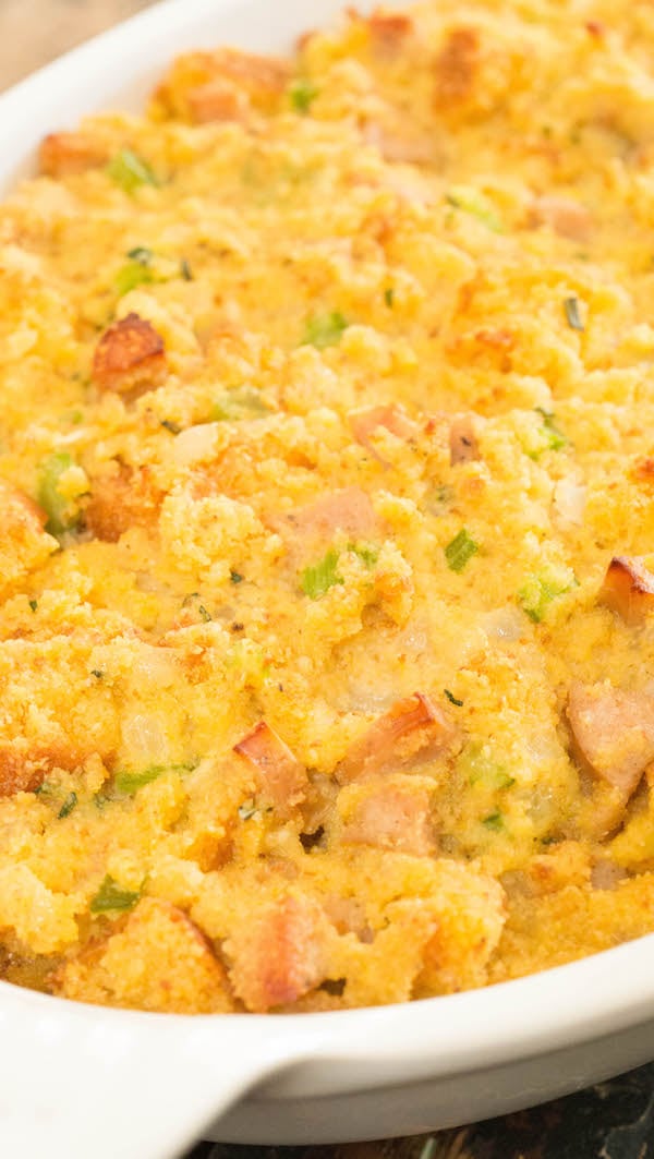 Cornbread stuffing with sausage in a white casserole dish