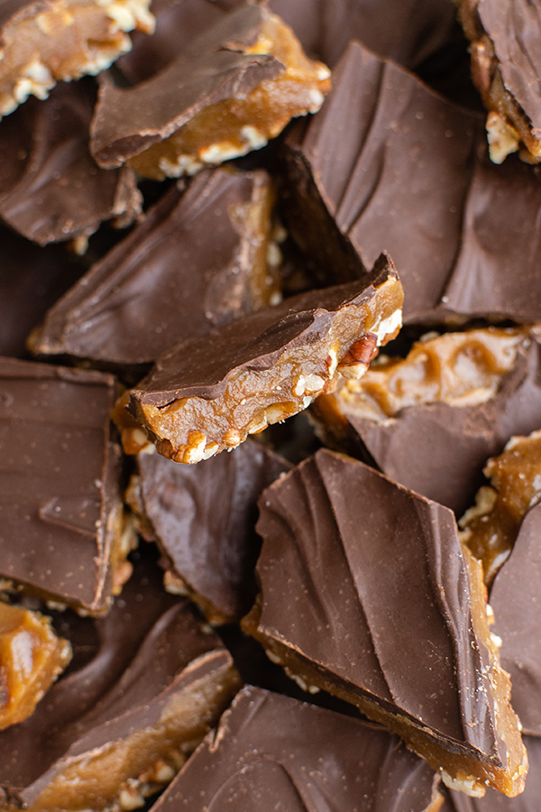 Close up shot of multiple pieces of butter toffee sitting on top of each other