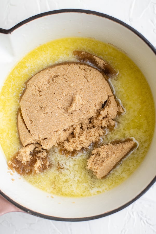 Overhead view of a sauce pan filled with melted butter and brown sugar