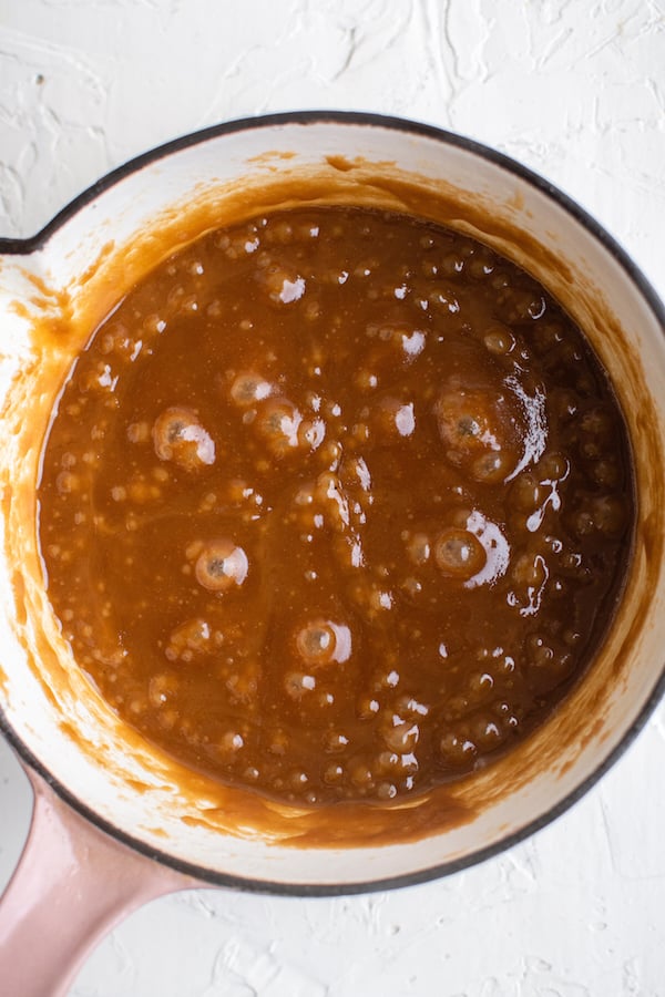 Overhead view of a sauce pan filled with butter and brown sugar that has turned rich brown and is bubbling