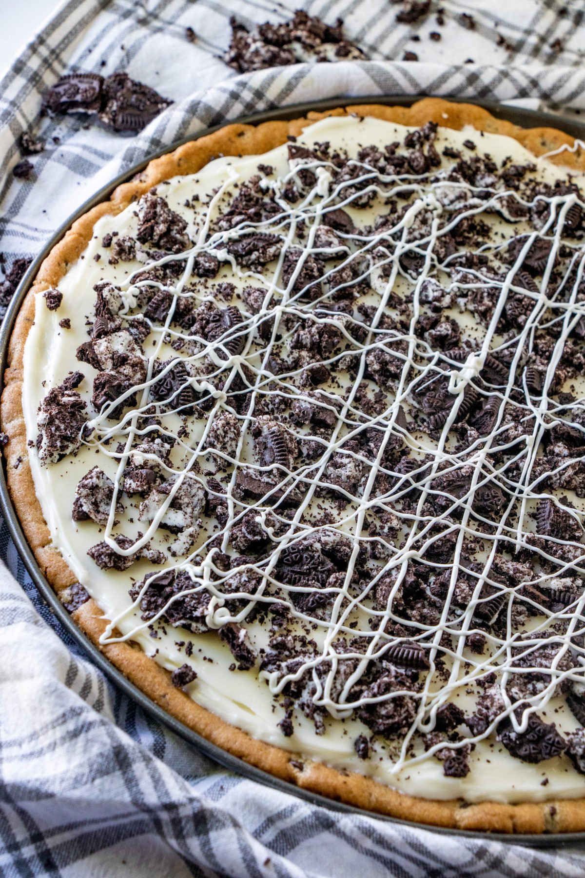 A cookies and cream pizza that has a chocolate chip cookie crust, cream "sauce", and crushed Oreos as a topping.