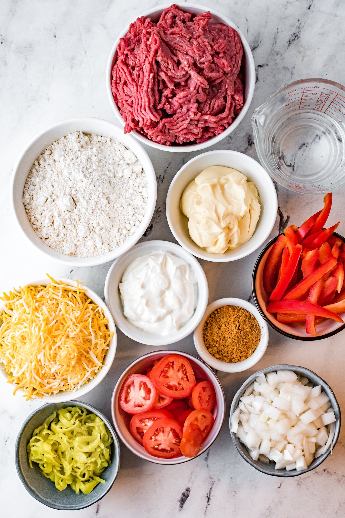 Overhead view of bowls filled with the raw ingredients to make John Wayne casserole.