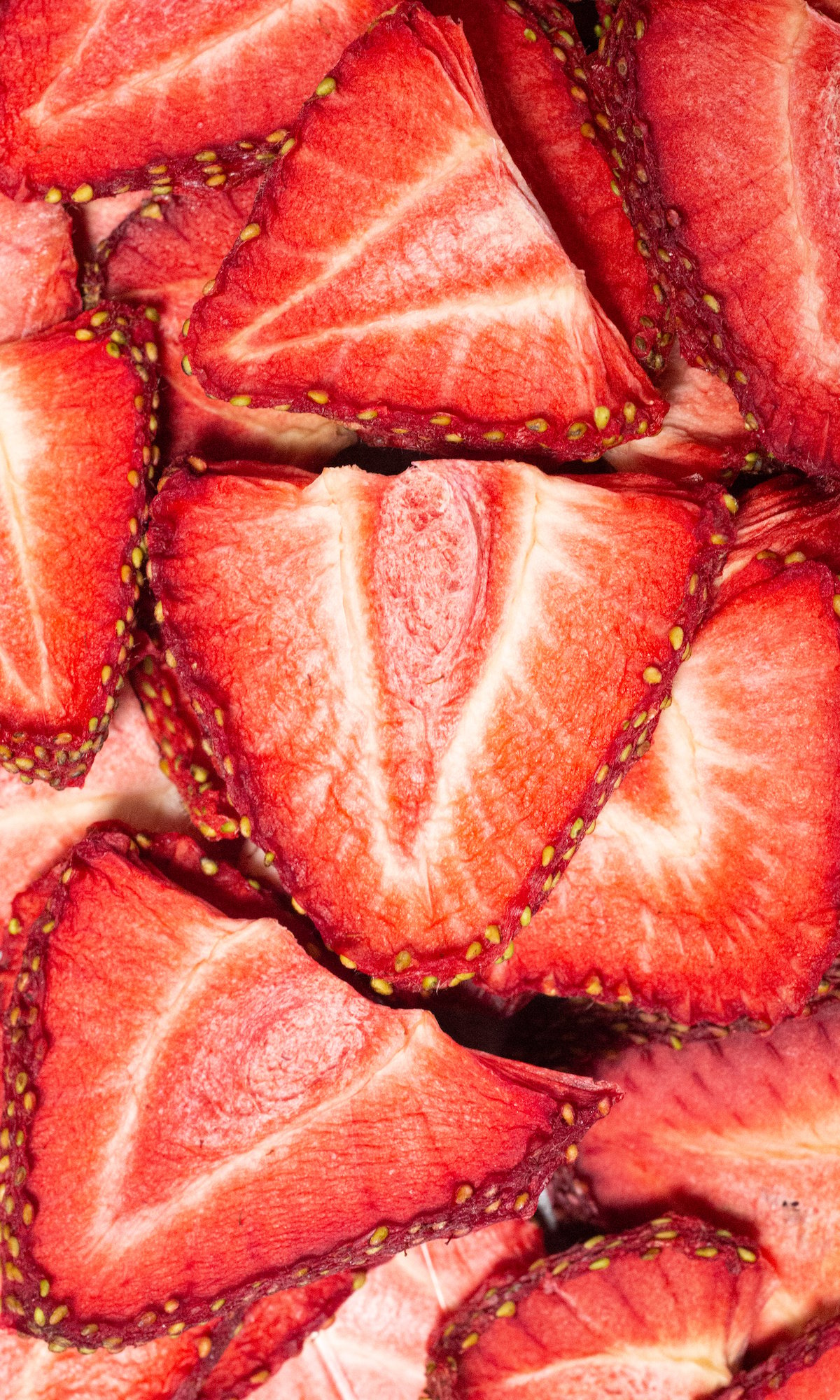 Overhead view of bright red strawberry slices that have been dehydrated.