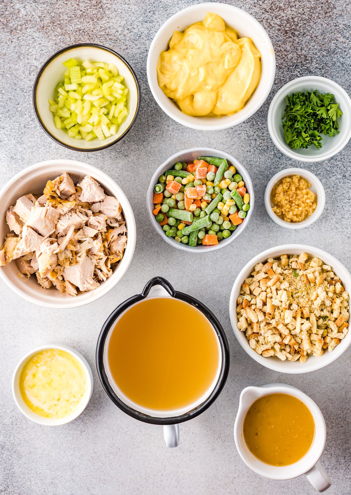 Overhead view of all the turkey casserole ingredients in prep bowls.