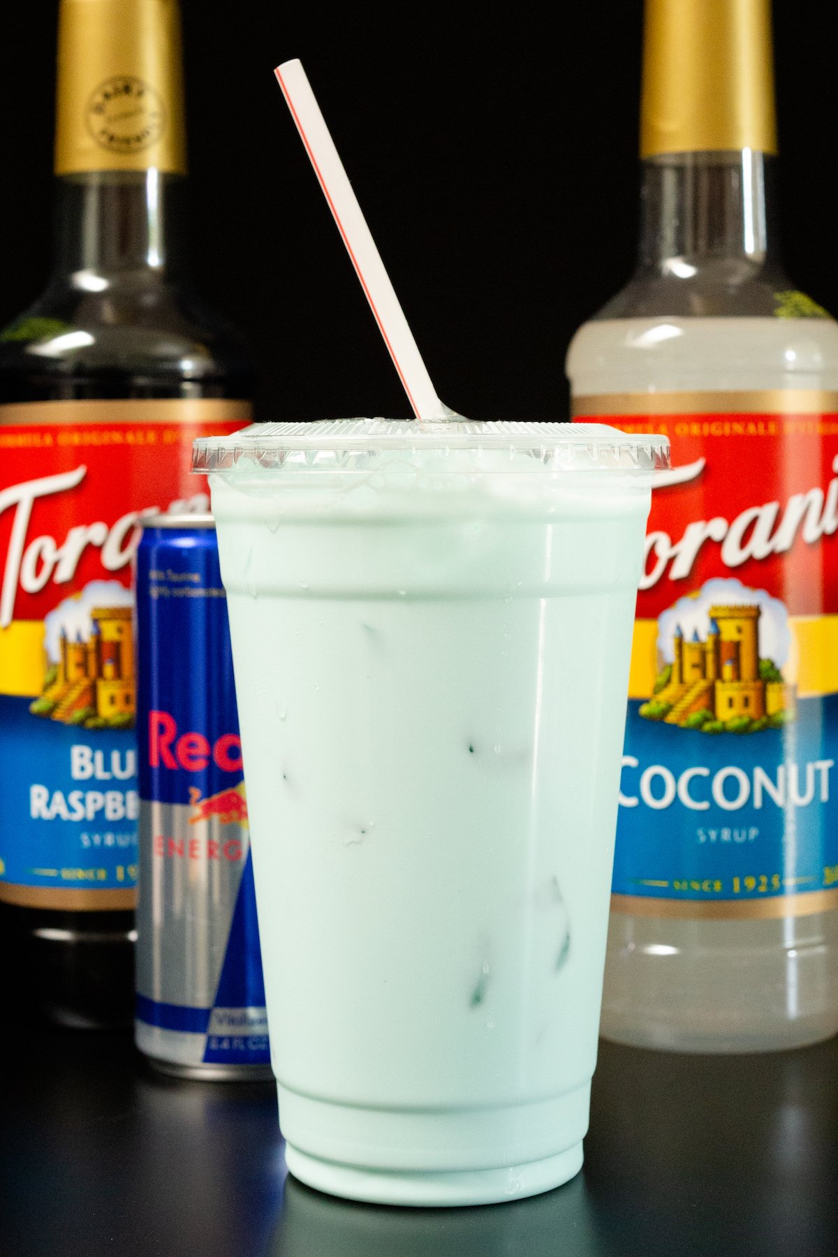 A large plastic cup filled with a blue Red Bull Italian Soda.