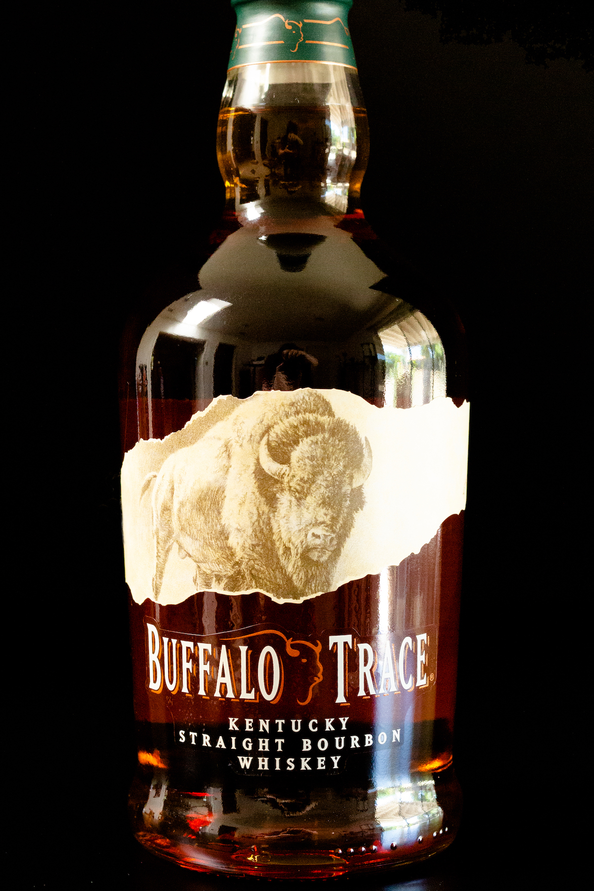 A bottle of Buffalo Trace Bourbon on a black background.