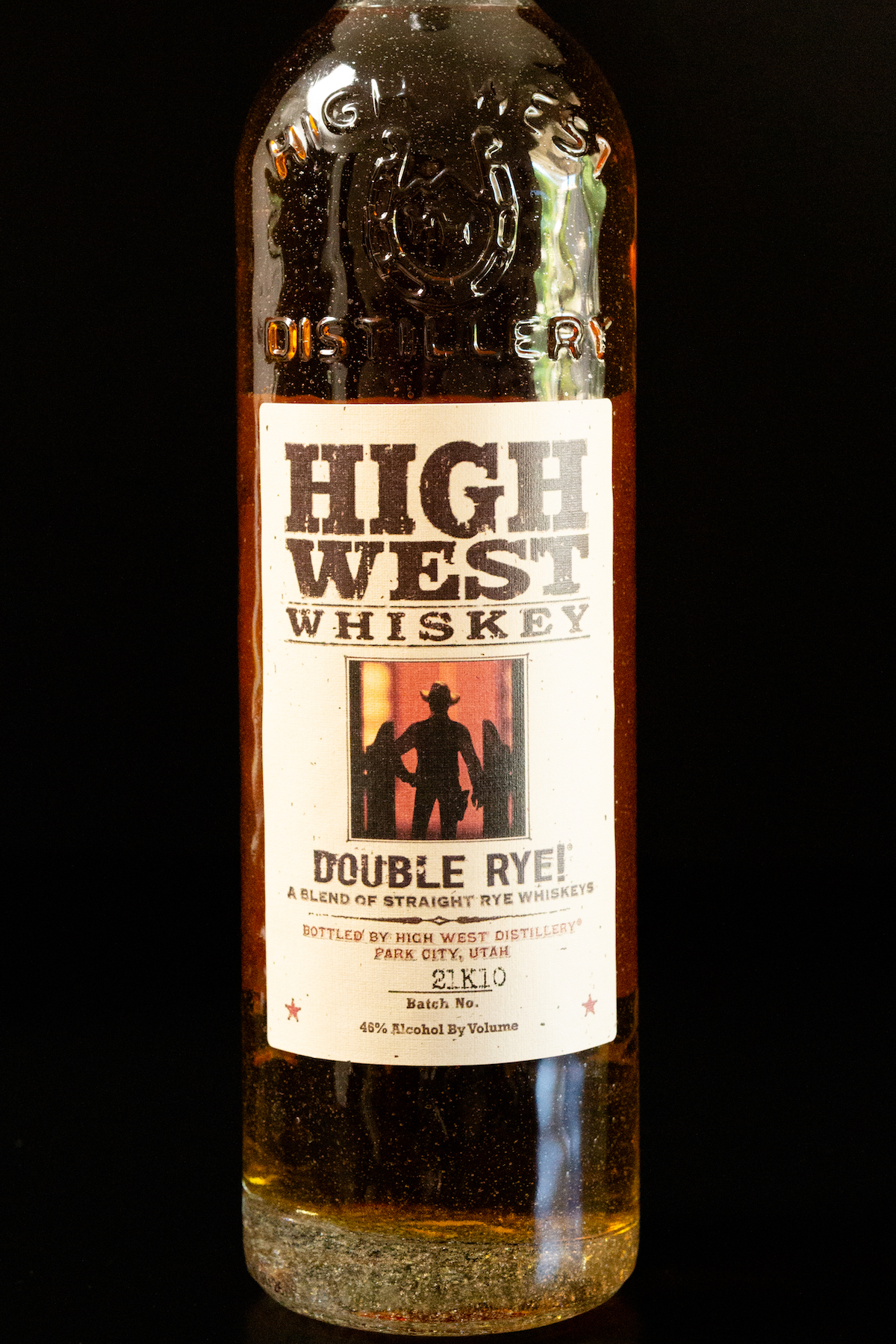 A bottle of High West Double Rye Whiskey on a black background.