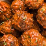 Close up of several Bison Meatballs lightly covered in BBQ sauce.