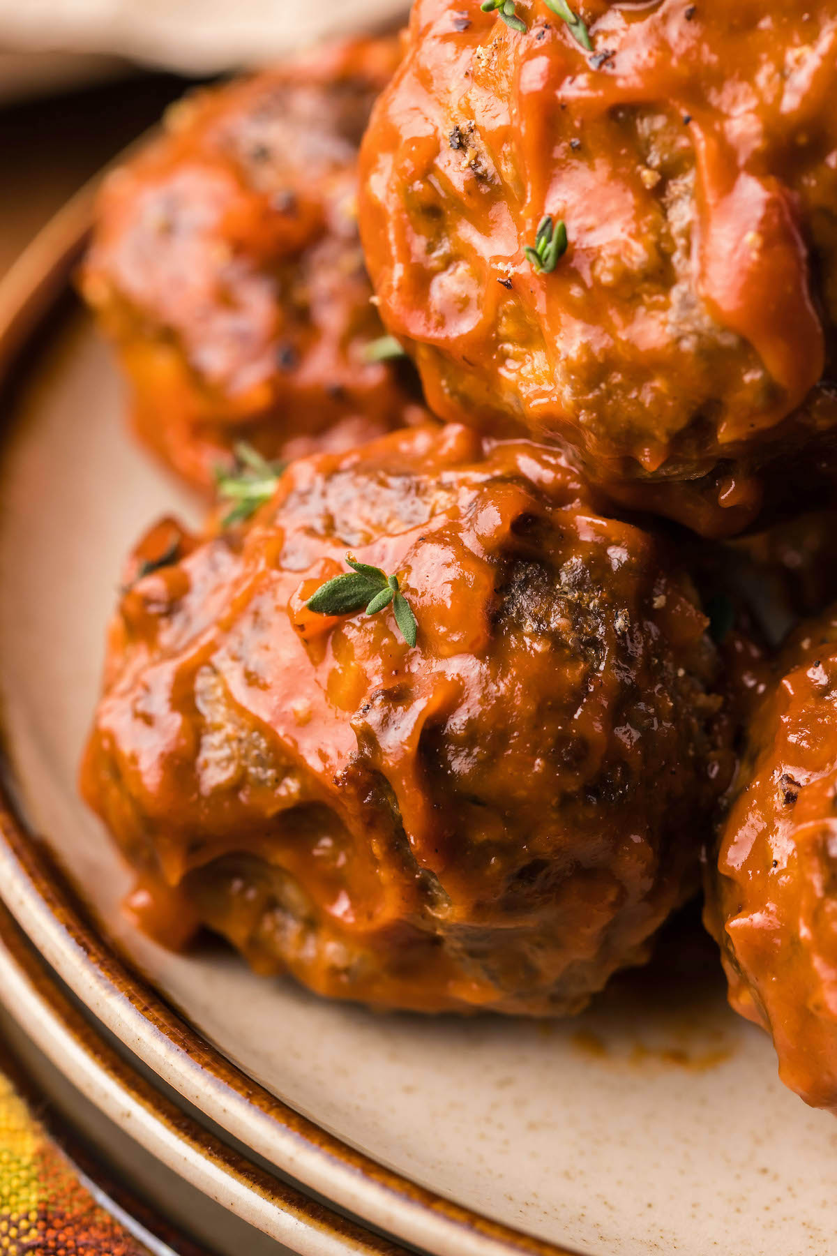 Close up of four homemade bison meatballs on a dinner plate.
