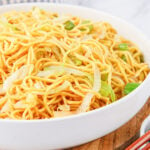 Close up of a white serving bowl filled with homemade Panda Express Chow Mein noodles.