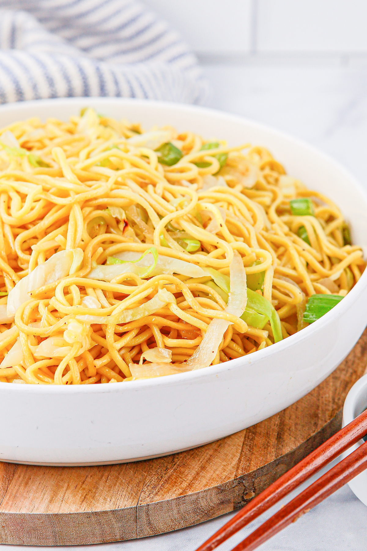Close up of a white serving bowl filled with homemade Panda Express Chow Mein noodles.