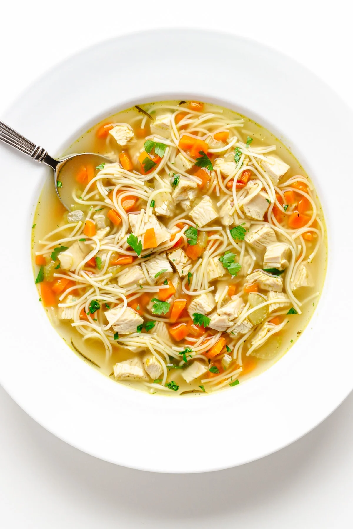 A large white soup bowl filled with Instant Pot turkey soup.