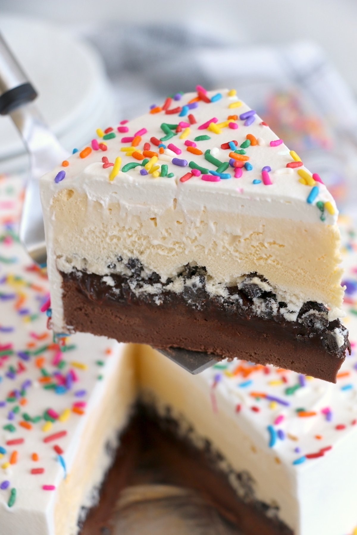 A metal pie server holds up a slice of copycat Dairy Queen Ice Cream Cake.