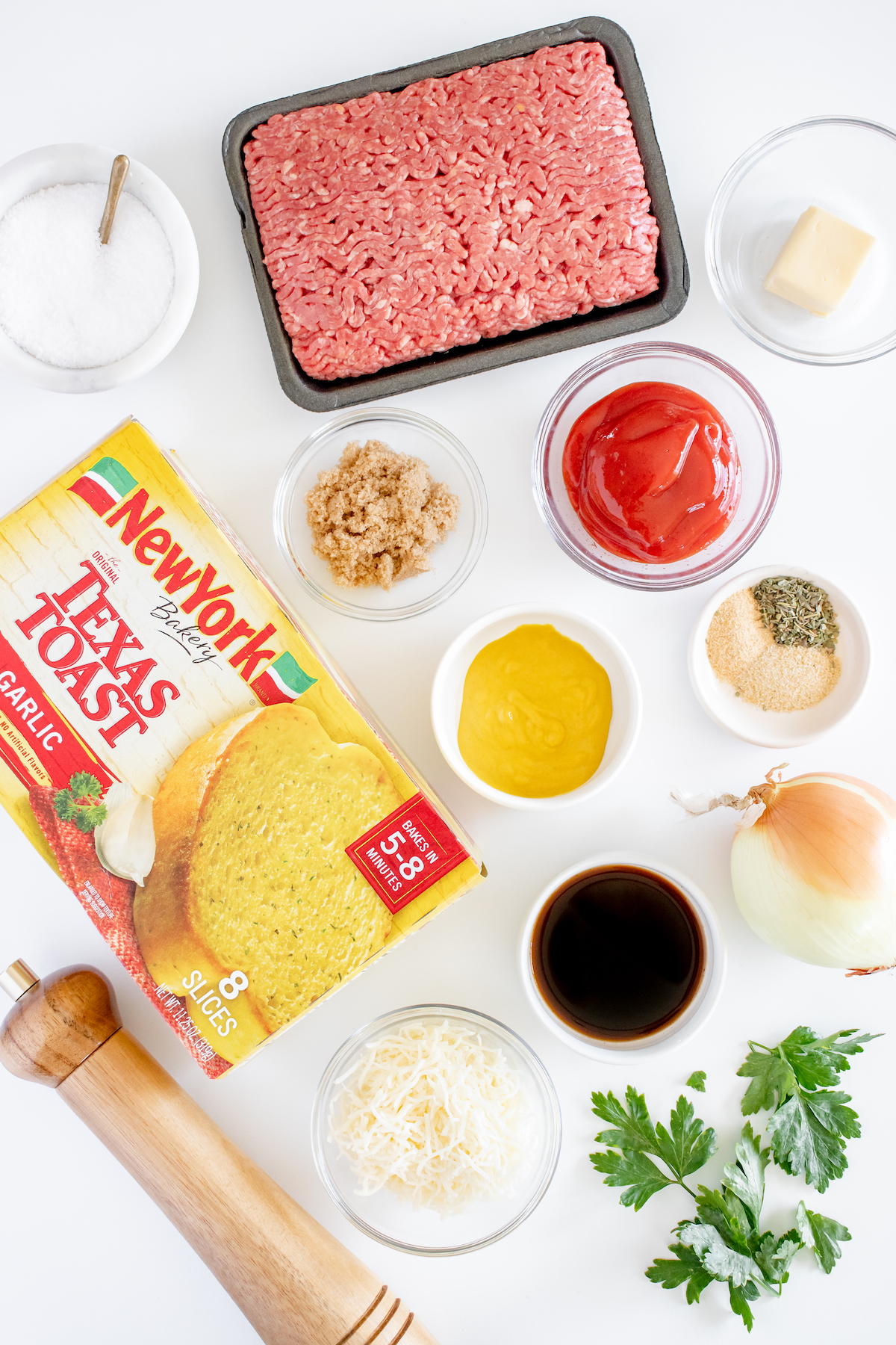 All the ingredients needed to make Texas Toast Sloppy Joes in prep bowls on a white background.