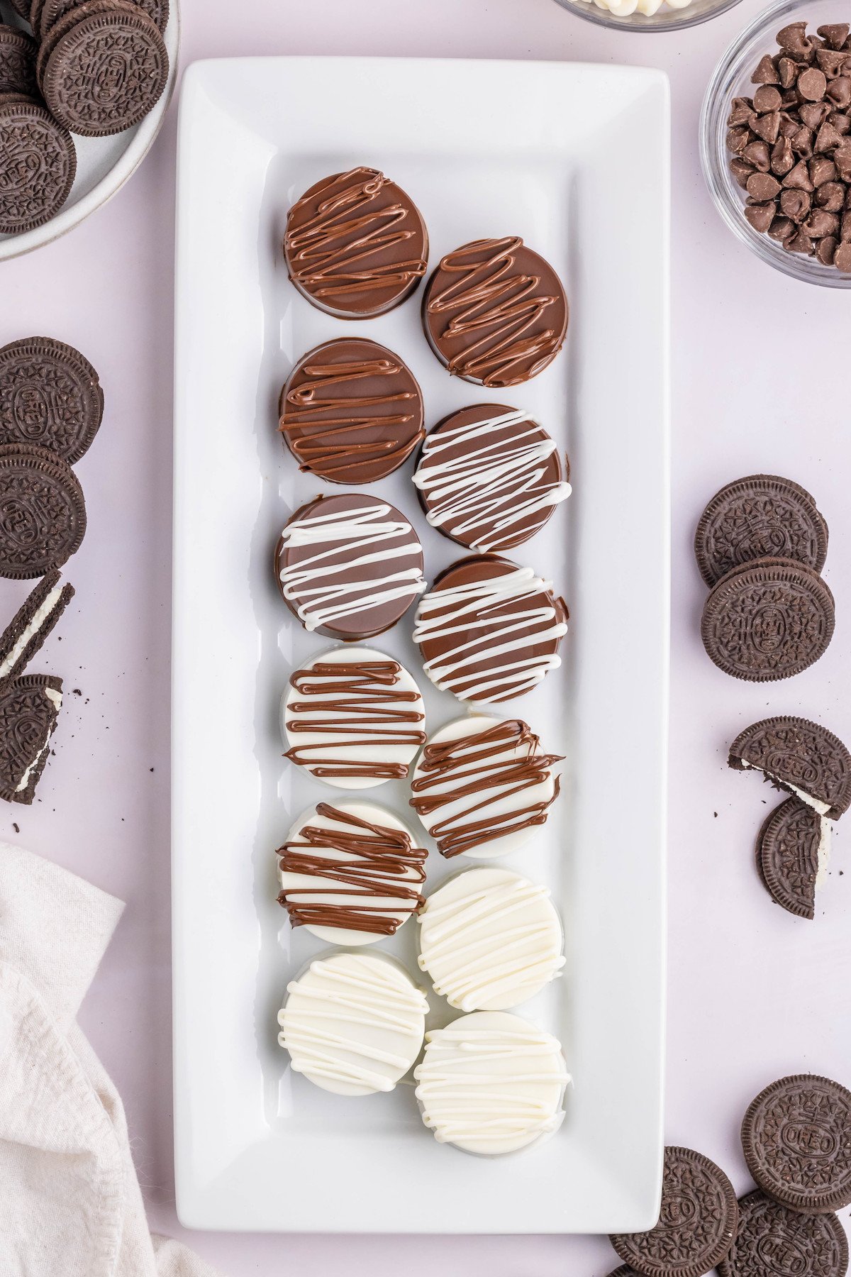 Overhead view of a serving platter filled with white and milk chocolate covered Oreo cookies.