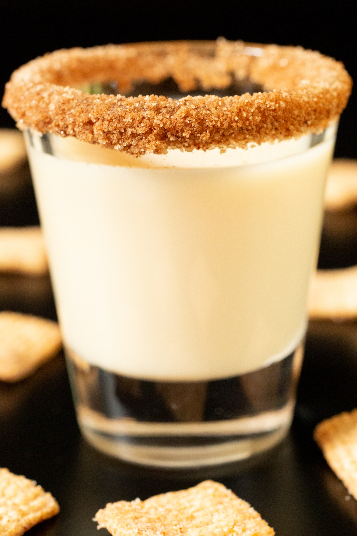Close up of a single cinnamon toast crunch shot surrounded by pieces of the cereal.