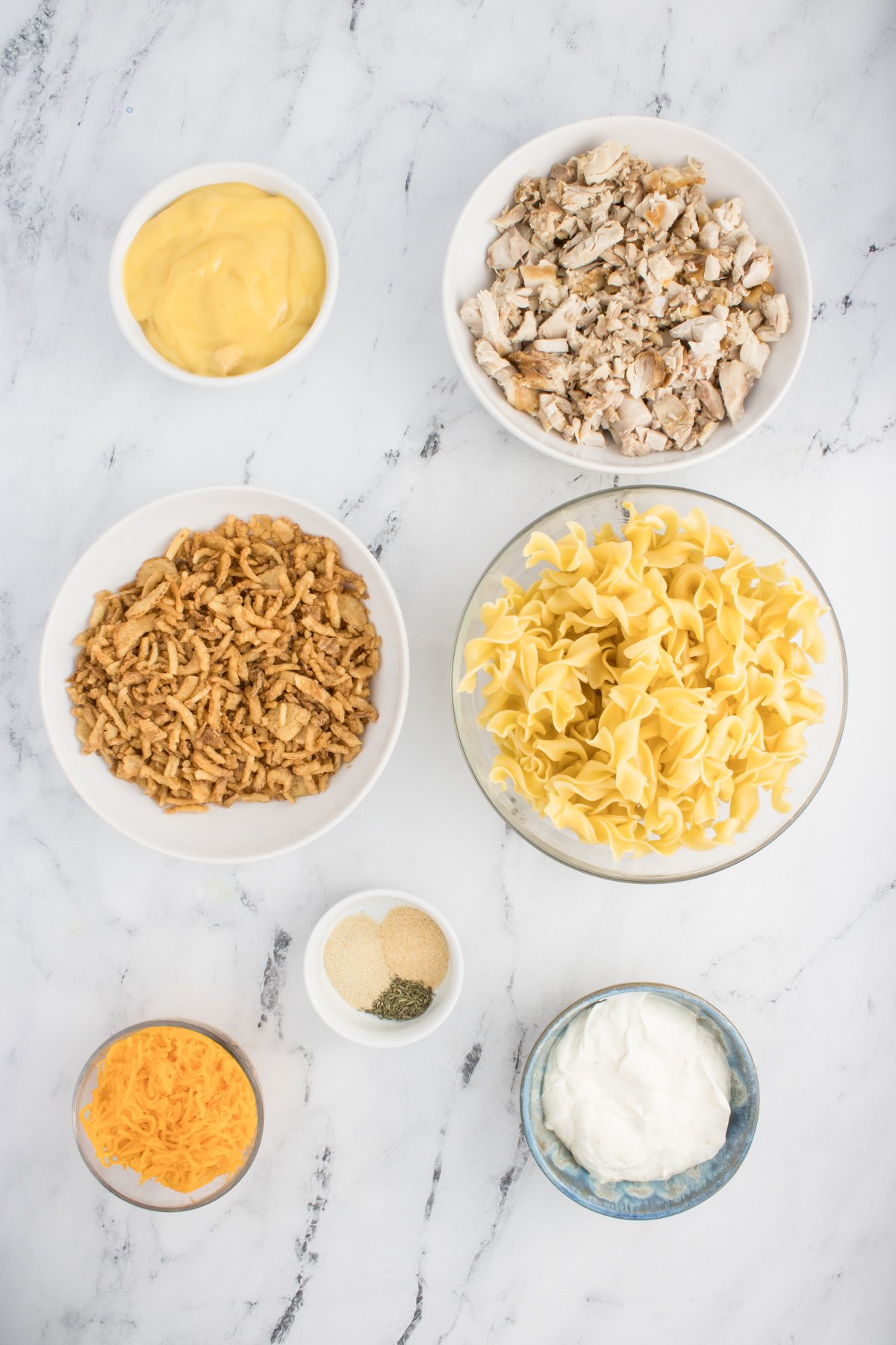 All the ingredients needed to make French Onion Chicken Casserole in prep bowls.