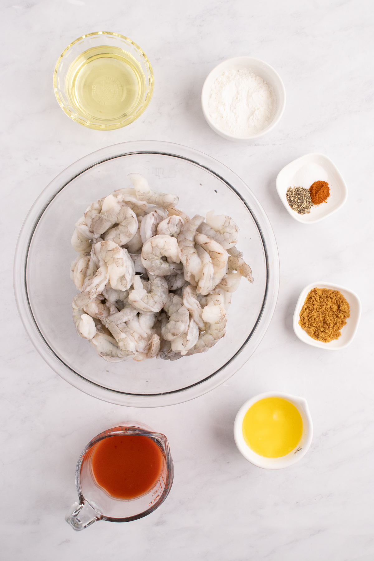 Prep bowls filled with all the ingredients you need to make buffalo shrimp.