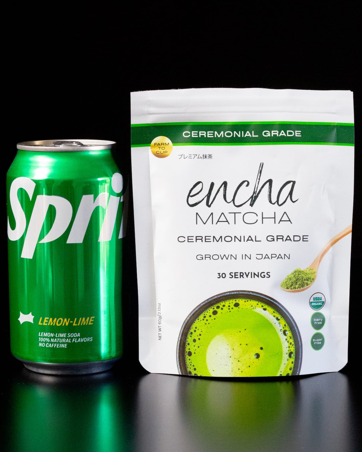 A can of Sprite soda and a bag of ceremonial grade matcha on a black background.