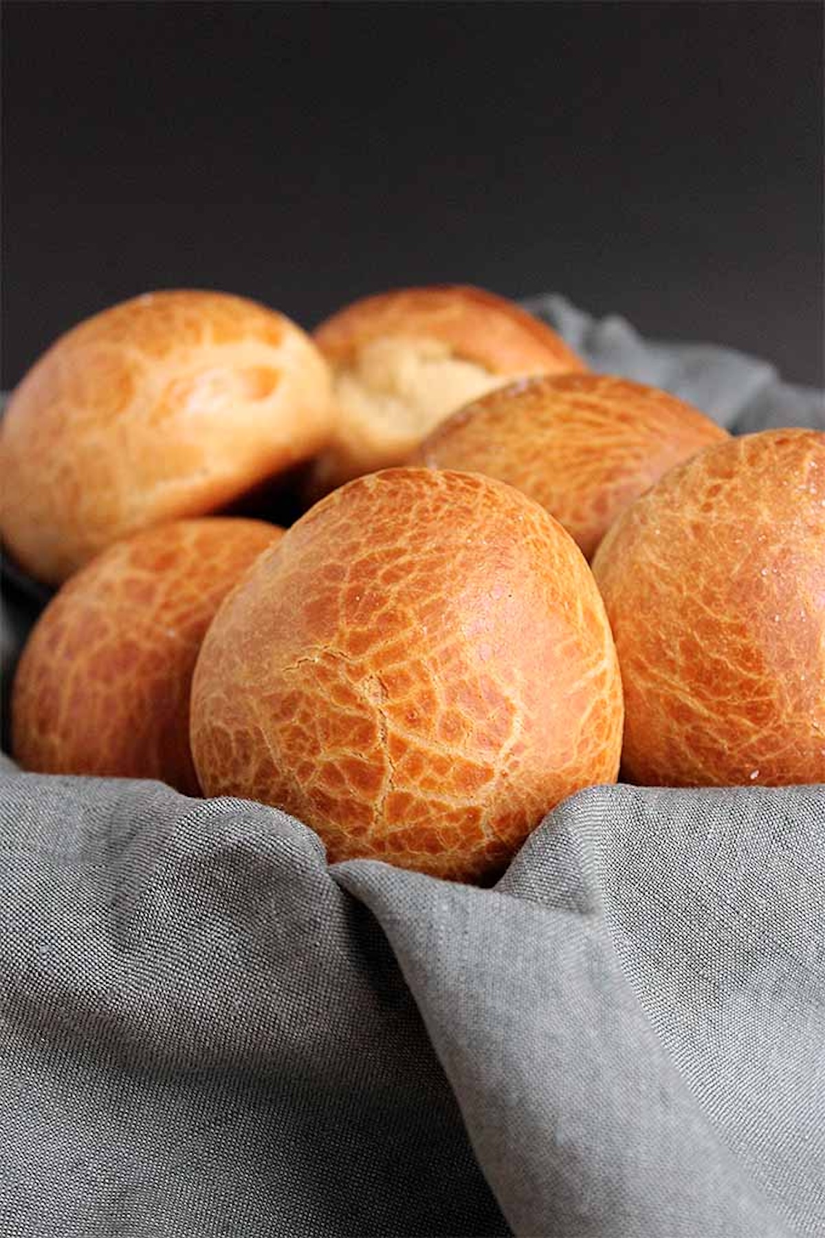A basket filled with homemade brown rolls.