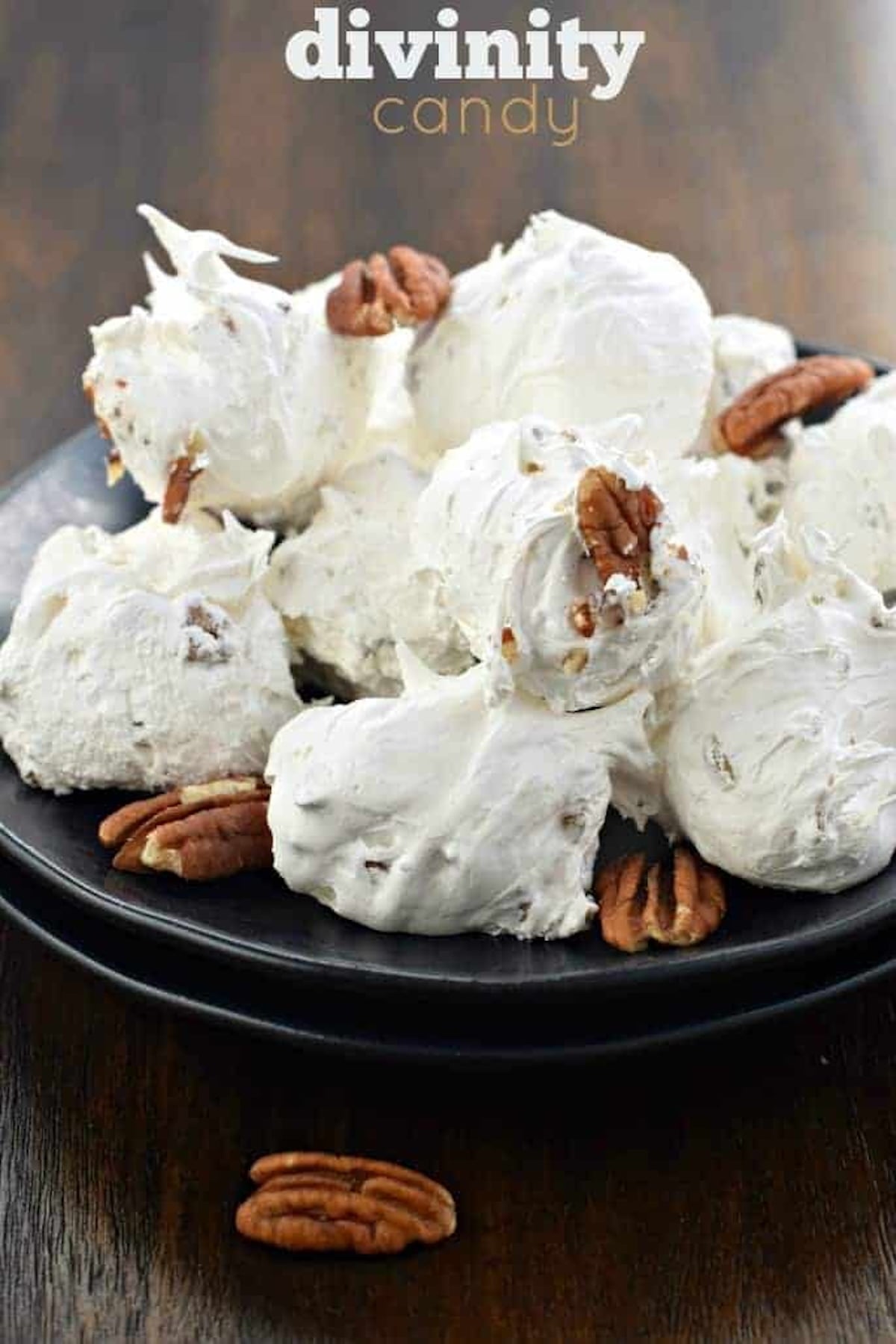 A serving plate filled with pieces of white candy with chopped pecans.