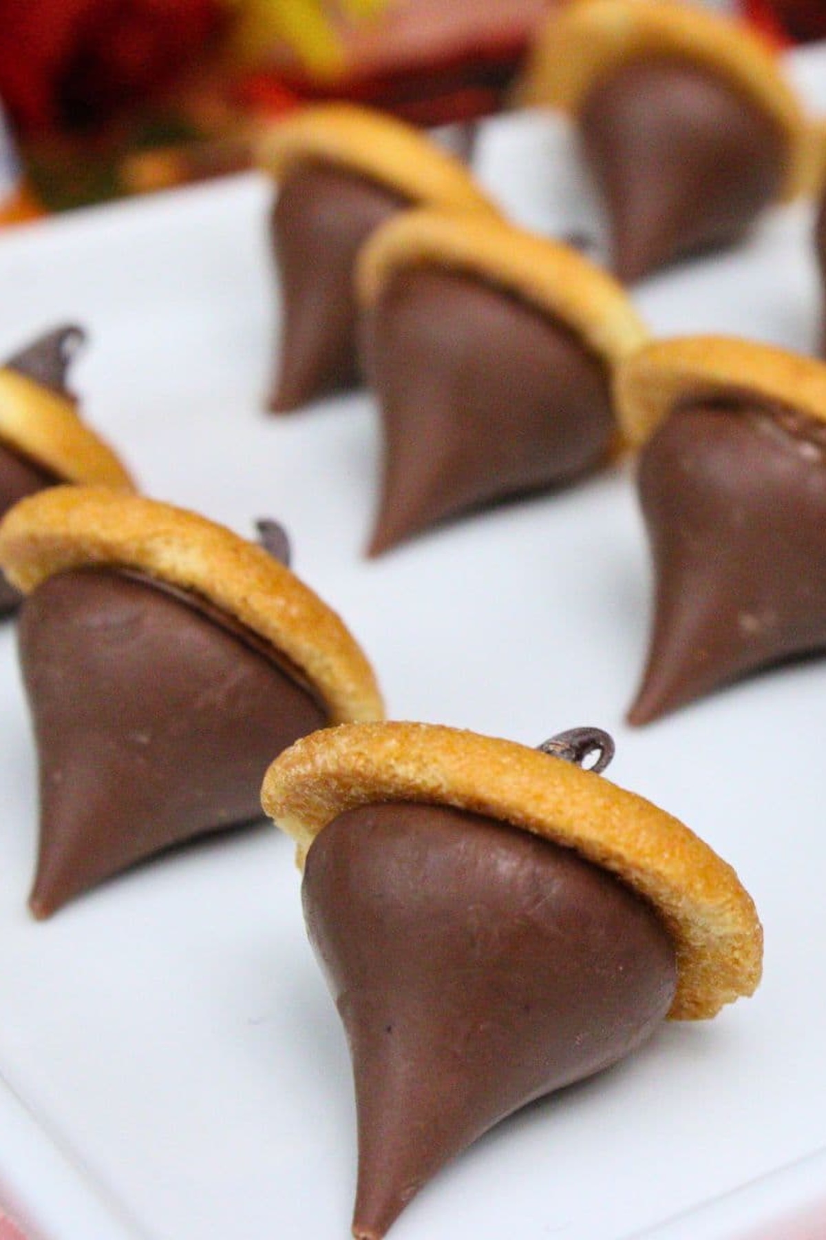 Hershey's kisses have been placed upside down on Nilla wafers to resemble acorns.